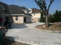 Large concrete driveway with cobblestone border finished