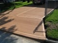 Beige colored concrete driveway with broomed finish
